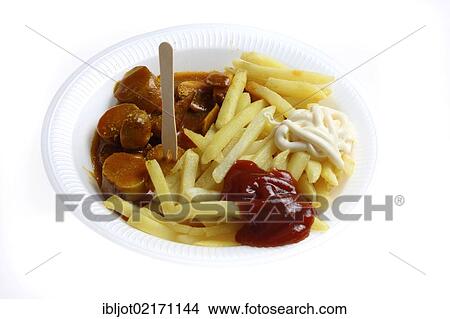 Picture - Fast food, French fries and sausage with curry powder on a paper plate with ketchup and mayonnaise. Fotosearch