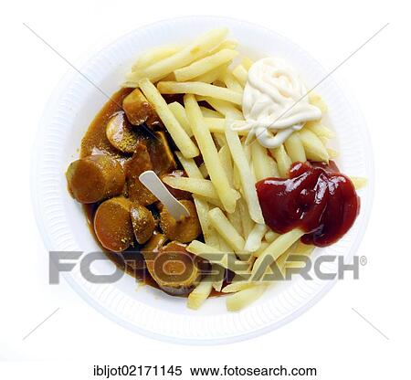 Stock Photography - Fast food, French fries and sausage with curry powder on a paper plate with ketchup and mayonnaise. Fotosearch