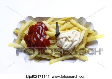 Stock Image - Fast food, French fries on a paper plate with ketchup and mayonnaise. Fotosearch