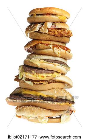 Stock Photo - Fast food, stacked hamburgers, cheeseburgers, chickenburgers, vegetable burgers and fish burgers. Fotosearch