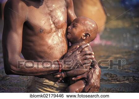 Stock Photograph - Father and child, ritual bath, Ghats, Ganges river, Kashi, Varanasi or Benares, Uttar Pradesh, India, Asia. Fotosearch