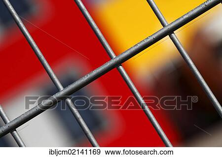 Fence in front of a colourful facade View Large Photo Image Stock Photo - Fence in front of a colourful facade. Fotosearch