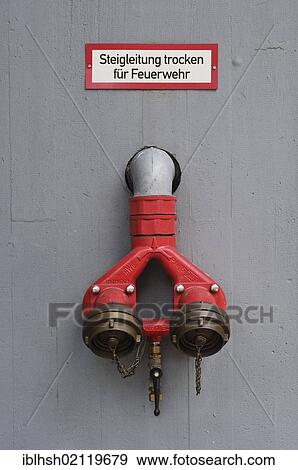 Fire protection, sign "Steigleitung trocken fuer Feuerwehr", German for 'ascending pipe dry for fire brigade', wall connection on building, PublicGround View Large Photo Image Stock Photo - Fire protection, sign "Steigleitung trocken fuer Feuerwehr", German for 'ascending pipe dry for fire brigade', wall connection on building, PublicGround. Fotosearch
