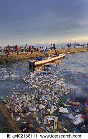 Fishermen landing their catch and taking it to the quay walls, floating plastic debris at front, Kota Biak, Biak Island, Irian Jaya, Indonesia, Southeast Asia, Asia View Large Photo Image Stock Image - Fishermen landing their catch and taking it to the quay walls, floating plastic debris at front, Kota Biak, Biak Island, Irian Jaya, Indonesia, Southeast Asia, Asia. Fotosearch