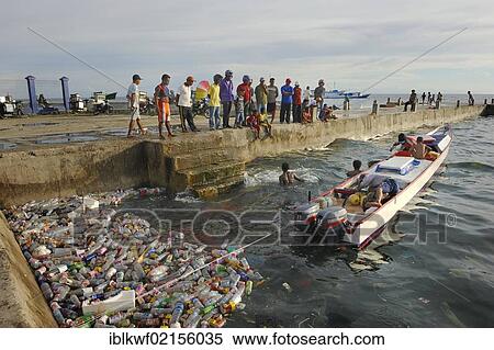 Fishermen landing their catch, taking it to the quay walls, floating plastic debris at front, Kota Biak, Biak Island, Irian Jaya, Indonesia, Southeast Asia, Asia View Large Photo Image Stock Photography - Fishermen landing their catch, taking it to the quay walls, floating plastic debris at front, Kota Biak, Biak Island, Irian Jaya, Indonesia, Southeast Asia, Asia. Fotosearch