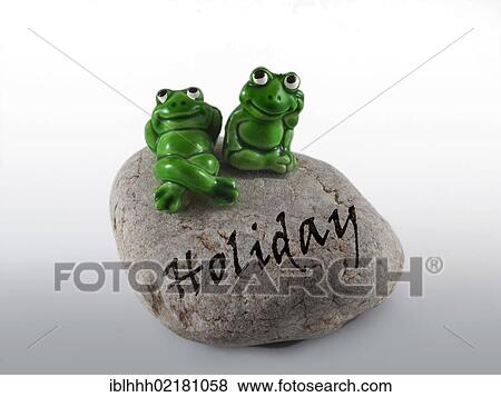 Stock Photo - Frog figures on a stone with the inscription Holiday. Fotosearch