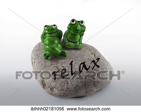 Stock Photograph - Frog figures on a stone with the inscription relax. Fotosearch