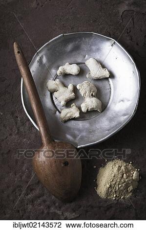 Ginger (Zingiber officinale) roots on a tin plate with a wooden spoon and ground ginger on a stone surface View Large Photo Image Stock Image - Ginger (Zingiber officinale) roots on a tin plate with a wooden spoon and ground ginger on a stone surface. Fotosearch