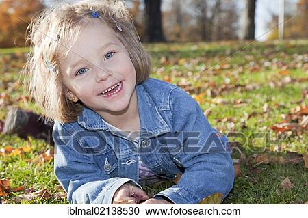 Girl, 4, in a park in autumn View Large Photo Image Stock Image - Girl, 4, in a park in autumn. Fotosearch