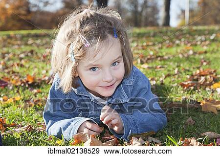 Girl, 4, in a park in autumn View Large Photo Image Stock Photo - Girl, 4, in a park in autumn. Fotosearch