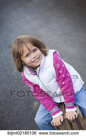 Girl, 4, sitting on a wooden crate View Large Photo Image Stock Photograph - Girl, 4, sitting on a wooden crate. Fotosearch
