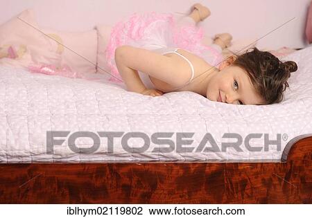 Girl, 5, wearing a ballet outfit on her bed View Large Photo Image Stock Image - Girl, 5, wearing a ballet outfit on her bed. Fotosearch