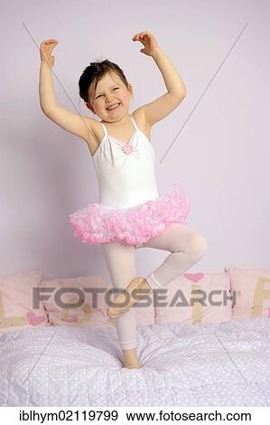 Stock Photo - Girl, 5, wearing a ballet outfit on her bed. Fotosearch