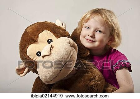 Girl, 5, with a stuffed monkey View Large Photo Image Stock Photo - Girl, 5, with a stuffed monkey. Fotosearch