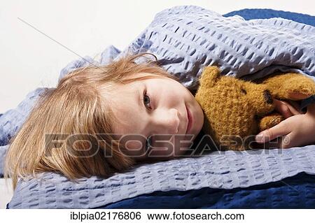 Girl, 5, with a teddy bear in bed View Large Photo Image Stock Photograph - Girl, 5, with a teddy bear in bed. Fotosearch