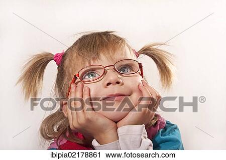 Stock Image - Girl, 5, with pigtails and glasses. Fotosearch
