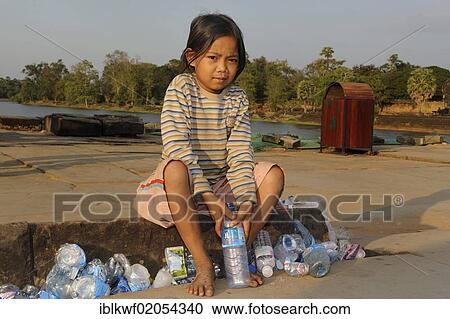 Girl collecting empty water bottles left by tourists and squashing them to earn money, in front of the Angkor Wat, Siam Reap, Cambodia, Southeast Asia, Asia View Large Photo Image Stock Image - Girl collecting empty water bottles left by tourists and squashing them to earn money, in front of the Angkor Wat, Siam Reap, Cambodia, Southeast Asia, Asia. Fotosearch