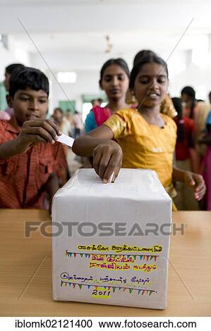 Girl putting ballot into voting box, mini Kutties Rajiyam, panchayat election, Noyyal Maravapalayam near Karur, Tamil Nadu, South India, Asia View Large Photo Image Stock Image - Girl putting ballot into voting box, mini Kutties Rajiyam, panchayat election, Noyyal Maravapalayam near Karur, Tamil Nadu, South India, Asia. Fotosearch