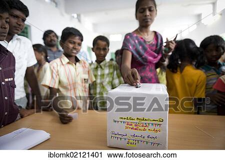 Stock Image - Girl putting ballot into voting box, mini Kutties Rajiyam, panchayat election, Noyyal Maravapalayam near Karur, Tamil Nadu, South India, Asia. Fotosearch