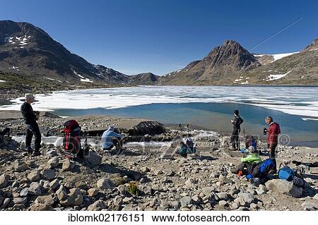 Group of hikers having a rest, at a lake near Tasiilaq or Ammassalik, East Greenland, Greenland, North America View Large Photo Image Stock Image - Group of hikers having a rest, at a lake near Tasiilaq or Ammassalik, East Greenland, Greenland, North America. Fotosearch