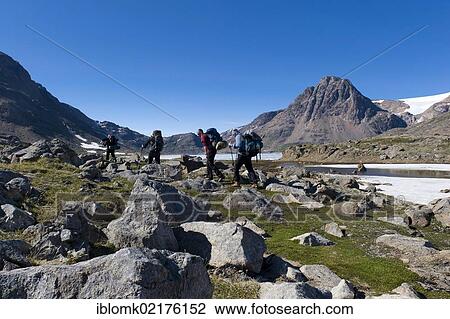 Stock Image - Group of hikers near Tasiilaq or Ammassalik, East Greenland, Greenland, North America. Fotosearch