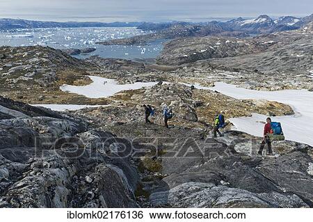 Group of hikers with a guide, icebergs near Tiniteqilaaq, Ammassalik Peninsula, at Sermilik Fjord, East Greenland, Greenland, North America View Large Photo Image Stock Photograph - Group of hikers with a guide, icebergs near Tiniteqilaaq, Ammassalik Peninsula, at Sermilik Fjord, East Greenland, Greenland, North America. Fotosearch