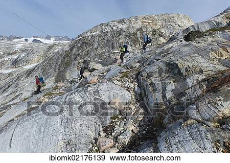 Stock Photo - Group of hikers with a guide, Ammassalik Peninsula, at Sermilik Fjord, East Greenland, Greenland, North America. Fotosearch