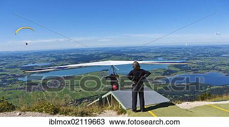 Hang glider starting from launching site, Mt Tegelberg, Froggensee Lake at back, Upper Bavaria, Germany, Europe, PublicGround, Europe View Large Photo Image Stock Image - Hang glider starting from launching site, Mt Tegelberg, Froggensee Lake at back, Upper Bavaria, Germany, Europe, PublicGround, Europe. Fotosearch