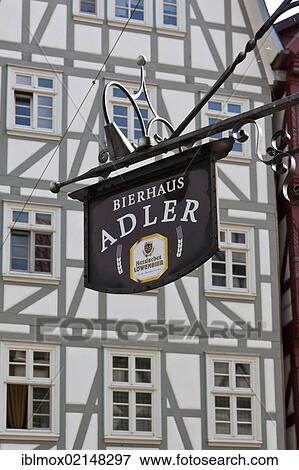 Hanging sign, Bierhaus Adler in front a half-timbered house, market place, Melsungen, Hesse, Germany, Europe, PublicGround, Europe View Large Photo Image Stock Photo - Hanging sign, Bierhaus Adler in front a half-timbered house, market place, Melsungen, Hesse, Germany, Europe, PublicGround, Europe. Fotosearch