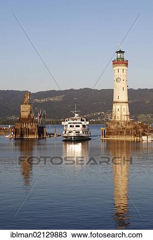 Stock Image - Harbour with lighthouse the Bavarian Lion, Lindau on Lake Constance, Swabia, Bavaria, Germany, Europe. Fotosearch