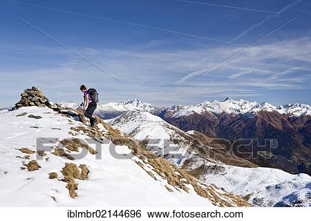 Hiker ascending Roethenspitz Mountain above Penser Joch Pass, mountains of the Pfitsch Valley at the rear with Hochfeiler Mountain, Sarn Valley, Alto Adige, Italy, Europe View Large Photo Image Stock Photograph - Hiker ascending Roethenspitz Mountain above Penser Joch Pass, mountains of the Pfitsch Valley at the rear with Hochfeiler Mountain, Sarn Valley, Alto Adige, Italy, Europe. Fotosearch