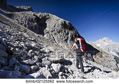 Hiker ascending the Alpinisteig climbing route through the Fischleintal Valley above the Talschluss Hut, looking towards Dreischusterspitze Mountain, Alta Pusteria, Sesto, Dolomites, Alto Adige, Italy, Europe View Large Photo Image Stock Image - Hiker ascending the Alpinisteig climbing route through the Fischleintal Valley above the Talschluss Hut, looking towards Dreischusterspitze Mountain, Alta Pusteria, Sesto, Dolomites, Alto Adige, Italy, Europe. Fotosearch