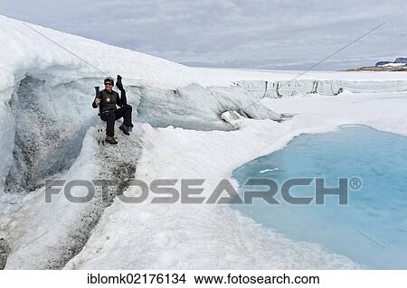 Hiker at Mittivakkat Glacier, Peninsula Ammassalik, East Greenland, Greenland, North America View Large Photo Image Picture - Hiker at Mittivakkat Glacier, Peninsula Ammassalik, East Greenland, Greenland, North America. Fotosearch