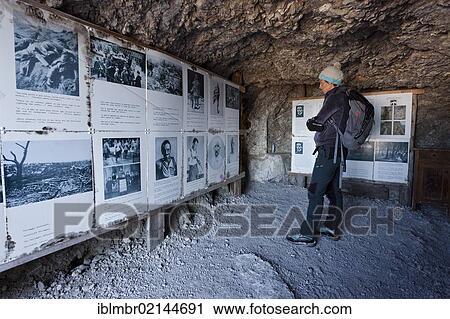 Stock Image - Hiker in the open air museum along the Bepi Zac climbing route in San Pellegrino Valley above San Pellegrino Pass, Dolomites, Trentino, Italy, Europe. Fotosearch