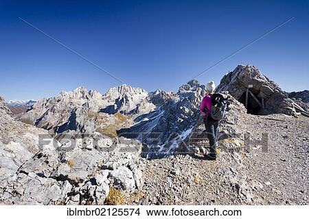 Hiker on Bepi Zac climbing route in the San Pellegrino Valley above the San Pellegrino Pass, currently on Costabela Mountain, with the Marmolada at the rear, Dolomites, Trentino, Italy, Europe View Large Photo Image Picture - Hiker on Bepi Zac climbing route in the San Pellegrino Valley above the San Pellegrino Pass, currently on Costabela Mountain, with the Marmolada at the rear, Dolomites, Trentino, Italy, Europe. Fotosearch
