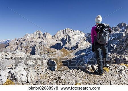 Stock Photo - Hiker on Costabella Mountain while ascending the Bepi Zac Climbing Route in the San Pellegrino Valley above the San Pellegrino Pass, looking towards Marmolada Mountain, Dolomites, Trentino, Italy, Europe. Fotosearch
