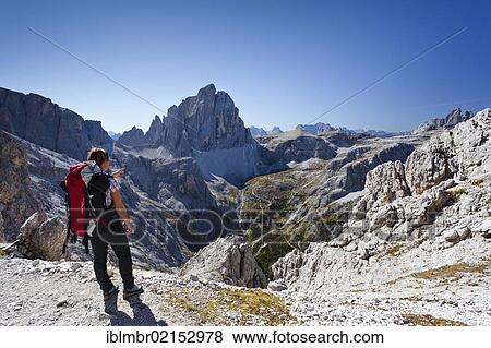 Hiker on Elferscharte Mountain, while climbing the Alpinisteig climbing route, looking towards Zwoelferkofel Mountain and The Three Peaks, Sesto, Alta Pusteria, Dolomites, Alto Adige, Italy, Europe View Large Photo Image Stock Photo - Hiker on Elferscharte Mountain, while climbing the Alpinisteig climbing route, looking towards Zwoelferkofel Mountain and The Three Peaks, Sesto, Alta Pusteria, Dolomites, Alto Adige, Italy, Europe. Fotosearch