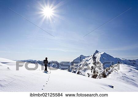 Picture - Hiker on Roethenspitz Mountain above Penser Joch Pass, looking towards the summit of Penser Weissenhorn Mountain, Sarn Valley, Alto Adige, Italy, Europe. Fotosearch