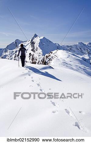 Stock Image - Hiker on Roethenspitz Mountain above the Penser Joch Pass, looking towards the summit of Penser Weisshorn Mountain, Sarntal Valley, Alto Adige, Italy, Europe. Fotosearch