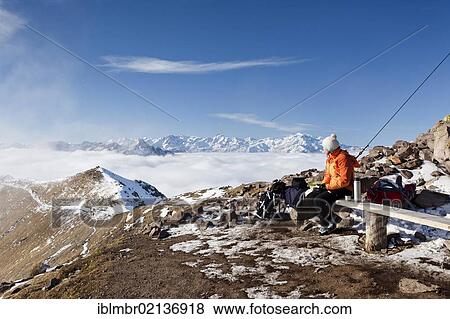 Hiker on the summit of Grosse Laugenspitze Mountain above the Laugenalm alpine pasture, looking towards the Ultner Mountains, Gampen Pass, Alto Adige, Italy, Europe View Large Photo Image Stock Photo - Hiker on the summit of Grosse Laugenspitze Mountain above the Laugenalm alpine pasture, looking towards the Ultner Mountains, Gampen Pass, Alto Adige, Italy, Europe. Fotosearch