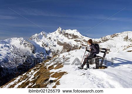 Stock Photo - Hiker resting while ascending Penser Weissenhorn Mountain above Penser Joch Pass, looking towards the summit of Penser Weissenhorn Mountain, Sarn Valley, Alto Adige, Italy, Europe. Fotosearch