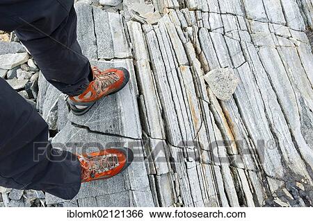Hiker standing at rock formations at the Mittivakkat Glacier, Ammassalik Peninsula, East Greenland View Large Photo Image Stock Photograph - Hiker standing at rock formations at the Mittivakkat Glacier, Ammassalik Peninsula, East Greenland. Fotosearch