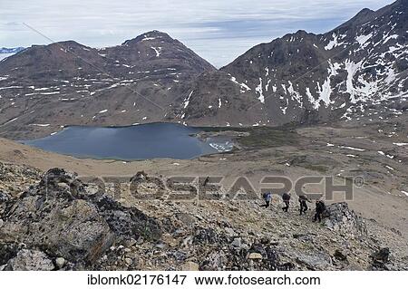 Hikers at a lake near Tasiilaq or Ammassalik, East Greenland, Greenland, North America View Large Photo Image Stock Photo - Hikers at a lake near Tasiilaq or Ammassalik, East Greenland, Greenland, North America. Fotosearch