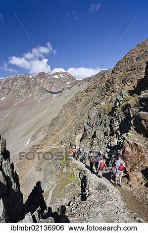 Stock Photograph - Hikers descending from Similaun Hut in the Schnalstal Valley through the Tisental Valley, Finailspitze Mountain at the rear, Alto Adige, Italy, Europe. Fotosearch