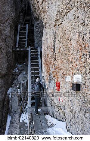 Stock Image - Hikers descending from the Bepi Zac climbing trail in the San Pellegrino valley above the San Pellegrino Pass, Dolomites, Trentino, Italy, Europe. Fotosearch