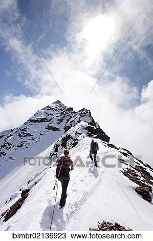 Hikers during the ascent along the summit ridge to Hinterer Eggenspitz Mountain in the Val d'Ultimo above Gruensee Lake, with the summit of Hinterer Eggenspitz Mountain at the rear, Alto Adige, Italy, Europe View Large Photo Image Stock Image - Hikers during the ascent along the summit ridge to Hinterer Eggenspitz Mountain in the Val d'Ultimo above Gruensee Lake, with the summit of Hinterer Eggenspitz Mountain at the rear, Alto Adige, Italy, Europe. Fotosearch