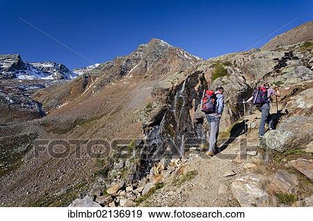 Hikers during the ascent to Hinterer Eggenspitz Mountain in the Val d'Ultimo above Weissbrunnsee Lake, Alto Adige, Italy, Europe View Large Photo Image Stock Photo - Hikers during the ascent to Hinterer Eggenspitz Mountain in the Val d'Ultimo above Weissbrunnsee Lake, Alto Adige, Italy, Europe. Fotosearch