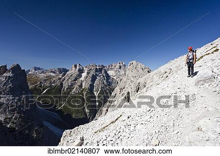 Hikers on the Alpinisteig climbing trail, Dreischusterspitze peak in the back, below the Fischleintal valley, Sexten, South Tyrol, Dolomites, South Tyrol, Italy, Europe View Large Photo Image Stock Photo - Hikers on the Alpinisteig climbing trail, Dreischusterspitze peak in the back, below the Fischleintal valley, Sexten, South Tyrol, Dolomites, South Tyrol, Italy, Europe. Fotosearch