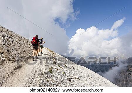 Hikers on the ascent to Mt. Sassongher above Corvara, Puezgruppe group, Puez-Geisler Nature Park, Dolomites, South Tyrol, Italy, Europe View Large Photo Image Stock Photo - Hikers on the ascent to Mt. Sassongher above Corvara, Puezgruppe group, Puez-Geisler Nature Park, Dolomites, South Tyrol, Italy, Europe. Fotosearch