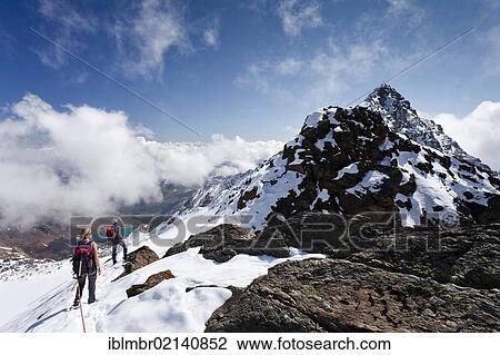 Hikers on the ascent to the Hintere Eggenspitze in the Ultental valley above Lake Gruensee, behind the Hintere Eggenspitze peak, below Lake Gruensee, South Tyrol, Italy, Europe View Large Photo Image Stock Image - Hikers on the ascent to the Hintere Eggenspitze in the Ultental valley above Lake Gruensee, behind the Hintere Eggenspitze peak, below Lake Gruensee, South Tyrol, Italy, Europe. Fotosearch